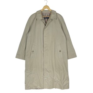 May include: A beige long-sleeved trench coat with a button closure and two flap pockets. The coat has a plaid lining and a collar.