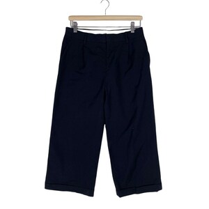 May include: Black wide-leg cropped pants with a cuffed hem.