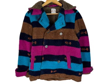 May include: A colorful striped jacket with a brown, pink, blue, and black pattern. The jacket has a hood with a brown faux fur lining and a double-breasted closure. The jacket has a "FITHAKA" label on the front.