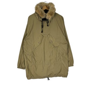 May include: A tan, long-sleeved jacket with a faux fur collar. The jacket has a drawstring hood and two large pockets on the front.