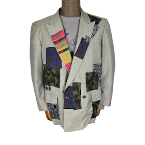 May include: A grey double-breasted blazer with a patchwork design featuring various fabrics in shades of blue, green, red, yellow, and black.
