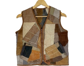 May include: A brown leather vest made of patchwork pieces. The vest has a zip closure and a variety of different shades of brown leather.