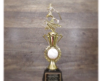 May include: Gold baseball trophy with a female baseball player figurine on top. The trophy has a baseball on the base and a black plaque with the text "Your Custom Engraving Here Up to 3 Lines".