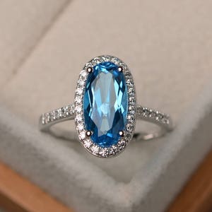 Swiss blue topaz ring, wedding ring, oval cut gems, halo ring, gemstone ring, sterling silver ring