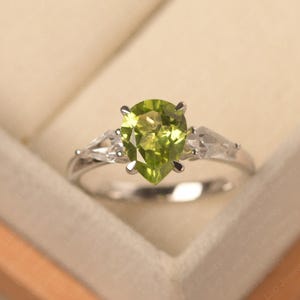 August birthstone, genuine natural peridot engagement ring, pear cut 7x9 mm, three stone ring