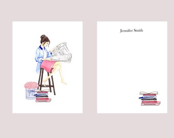 May include: A woman sits on a stool reading a newspaper. She is wearing a blue shirt and a pink skirt. There are pink flowers in a white box and a stack of books with the word "FASHION" on them.