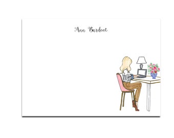 May include: A woman with blonde hair sits at a desk with a laptop, a lamp, and a vase of flowers. The desk is white with a light wood top. The woman is wearing a striped shirt and brown pants. The text "Ann Bardot" is at the top of the image.
