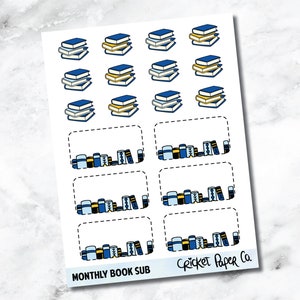 May include: A sheet of stickers featuring stacks of books in blue and yellow, along with rectangular boxes with book illustrations. The text "MONTHLY BOOK SUB" and "Cricket Paper Co." are printed at the bottom.