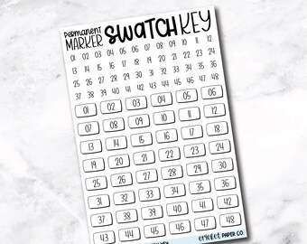 May include: A white Permanent Marker Swatch Key with a grid of numbered boxes. The text "PERMANENT MARKER SWATCH KEY" is at the top. The key is designed to help organize and identify permanent marker colors.