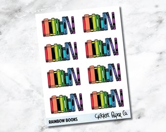 May include: A sheet of stickers featuring colorful, illustrated stacks of books. Each stack includes books in shades of red, orange, yellow, green, blue, and purple. The text "RAINBOW BOOKS" is printed at the bottom.