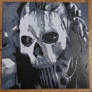 May include: A black and white painting of a person wearing a skull mask. The mask is painted in a realistic style and has a menacing expression. The person is wearing a headset and has a microphone attached to their chest.