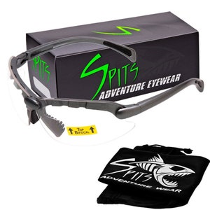 May include: Gray and black safety glasses with a clear lens and a bifocal lens marked "Top Bifocal". The glasses are in a black box with the text "SPITS ADVENTURE EYEWEAR" in green. The glasses also come with a black pouch with the text "SPITS ADVENTURE WEAR" in white.