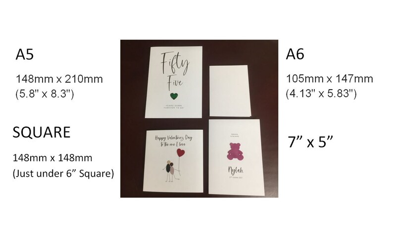 May include: Four blank greeting cards in different sizes, including A5 (5.8" x 8.3"), A6 (4.13" x 5.83"), and square (just under 6" square). The cards are white with a smooth finish. One card has the text "Fifty Five" printed on it.