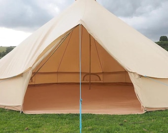 May include: A large, beige, conical bell tent with a wide, open entrance. The structure features a central pole, a tan floor, and a bright blue guy line secured to the ground with a metal stake. The exterior fabric is smooth and light-colored.