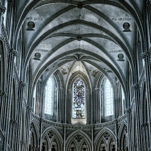 May include: A high-ceilinged cathedral interior with arched stone ceilings and stained glass windows. The windows are tall and narrow, and the stonework is intricate and detailed. The ceiling is vaulted and has a series of arches that create a sense of grandeur and height.