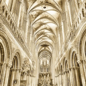 May include: A sepia-toned photograph of the interior of a large cathedral with high vaulted ceilings and rows of pews. The cathedral is very ornate with intricate stonework and arches.