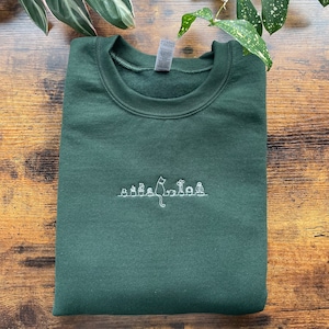 Cat Sitting On A Shelf With Plants Embroidered Sweatshirt