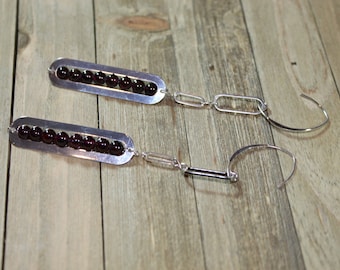 Oblong silver oval earrings with embedded rhodolite garnet round beads on sterling silver earwires