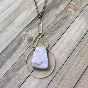 Geometric funky peruvian pink opal pendant inside brass circle suspended from brass ovals on antique gold chain