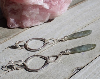 Labradorite teardrop wire wrapped and suspended from silver diamonds and horseshoe shapes on silver 925 sterling silver french hooks