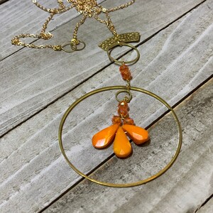 Faceted orange coral teardrops with czech glass beads hand wired to copper circle suspended on gold colored chain image 1