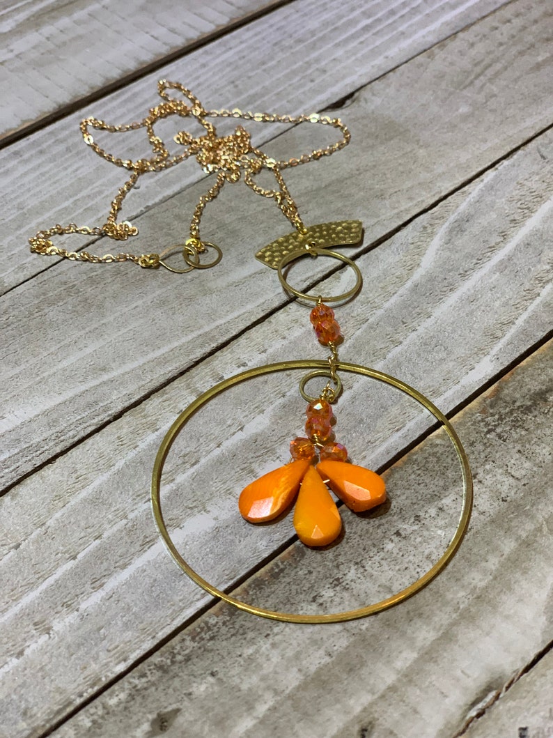 Faceted orange coral teardrops with czech glass beads hand wired to copper circle suspended on gold colored chain image 1