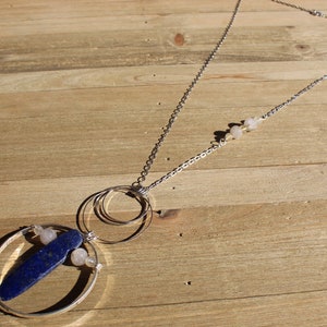 Lapis lazuli and rutile gold quartz floating inside silver circles with rutile quartz beads embedded in silver chain image 1