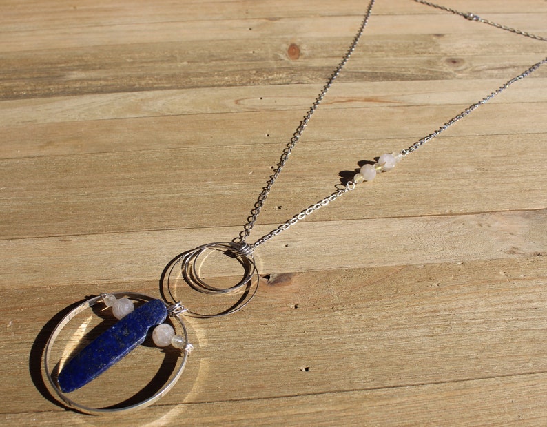 Lapis lazuli and rutile gold quartz floating inside silver circles with rutile quartz beads embedded in silver chain image 1