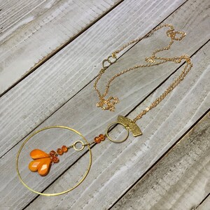 Faceted orange coral teardrops with czech glass beads hand wired to copper circle suspended on gold colored chain image 2