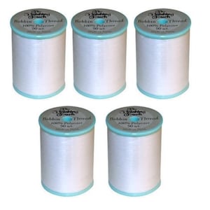 May include: Five spools of white bobbin thread are arranged on a white background. Each spool has a light blue rim and a label that reads "The Finishing Touch Bobbin Thread 100% Polyester 90 wt. Made in Japan."