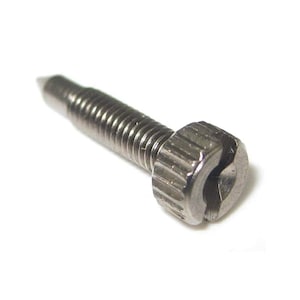 May include: Close-up of a silver metal screw with a slotted head. The screw has a pointed tip and a threaded shaft. The head of the screw is hexagonal with a slot for a screwdriver.