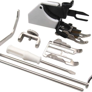 May include: A sewing machine presser foot set with various attachments. The set includes a white and black presser foot, several metal feet, a screwdriver, and other small tools. The tools are arranged on a white background.
