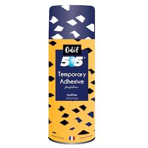 May include: A cylindrical can of Odif 505 Temporary Adhesive for fabric. The top is navy blue with white brushstroke designs. The main body is yellow with black diamond shapes. The label is navy blue with white text.
