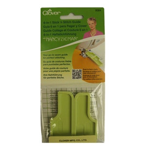 May include: A green Clover 6-in-1 Stick'n Stitch Guide in a clear plastic package. The package features text in multiple languages and a photo of Nancy Zieman. The guide is designed for perfect stitching.