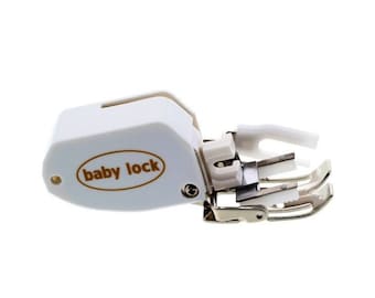 May include: A white Baby Lock sewing machine foot with a metal and plastic design. The foot has a curved shape with multiple prongs and the brand name in a brown oval.