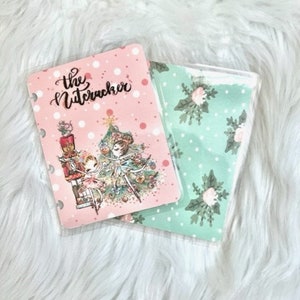 May include: Two planner covers, one pink with white polka dots and the text "The Nutcracker" and the other green with white polka dots and a floral pattern.