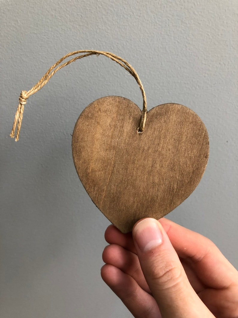 May include: A brown wooden heart-shaped ornament with a twine string attached.