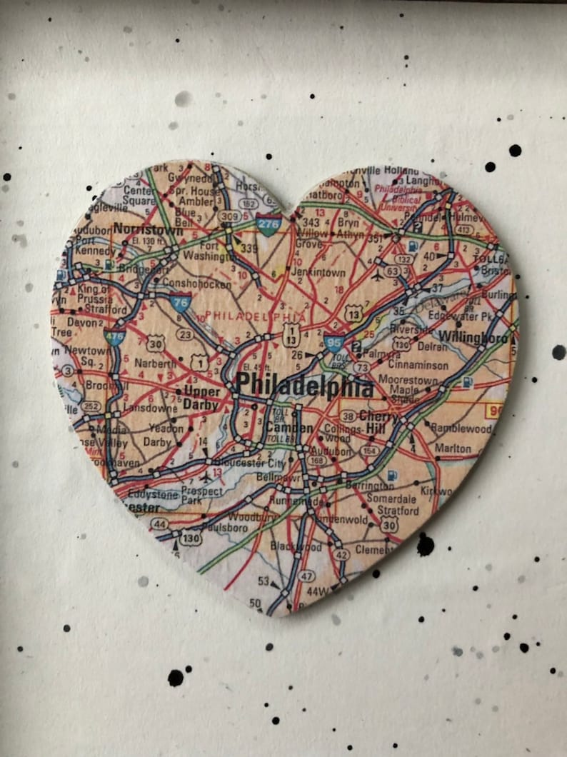 May include: A heart-shaped map of Philadelphia, Pennsylvania, with major roads and highways highlighted. The map is made of wood and has a distressed, vintage look.