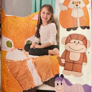 May include: Simplicity pattern featuring a child with a large orange fox-shaped pillow. Additional patterns include a fox, monkey, and horse. The pattern is labeled "U.S. ONE SIZE".