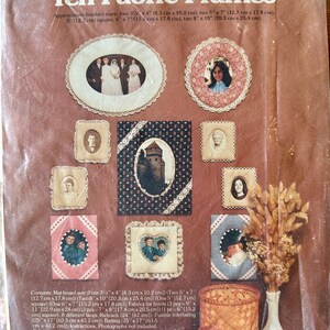 May include: A soft frame kit by Country Fair with ten fabric frames. The kit includes various sizes, from 3.25" x 4" to 8" x 10", with mat board sets, fabrics, laces, and fusible interfacing. The frames are designed for photographs.