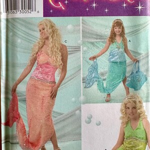 May include: Simplicity Costumes pattern featuring mermaid costumes in pink, green, and teal. The costumes include mermaid tails and tops. The pattern includes the text "Costumes" and "All Sizes".