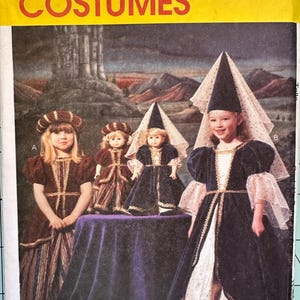 May include: A McCall's Costumes sewing pattern envelope featuring illustrations of two children and two dolls wearing medieval-style velvet dresses with gold trim, puff sleeves, and headpieces, set against a landscape with a castle.