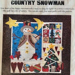 May include: A quilt pattern titled "Country Snowman" featuring a whimsical snowman with a carrot nose, wearing a hat and scarf. The design includes stars, hearts, and a Christmas tree, with the text "TRS Designs" and "Pattern Collection".
