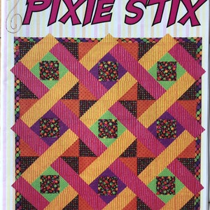 May include: A colorful quilt pattern titled "PIXIE STIX" by Diane Weber. The design features a repeating geometric pattern in shades of orange, pink, purple, and green. The quilt size is approximately 48" x 48".