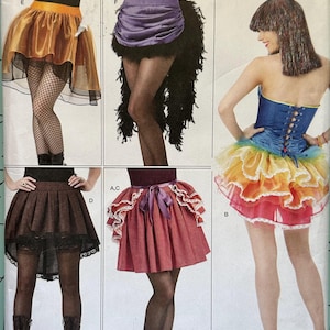 May include: Simplicity sewing pattern 1346 H5 for skirts in sizes 6-14. The envelope displays five skirt variations: a gold satin skirt, a purple satin skirt with black feathers, a rainbow tiered skirt, a brown pinstripe skirt, and a red skirt.