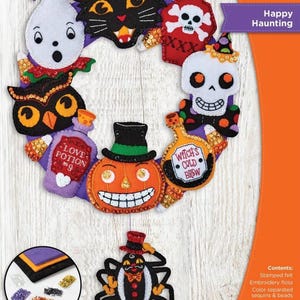 May include: A Bucilla felt wreath kit titled Happy Haunting, measuring 12.75 inches by 18 inches. The kit features felt pieces including a black cat, ghost, skull, pumpkin, spider, and potion bottles with text Love Potion No. 9 and Witch's Cold Brew.