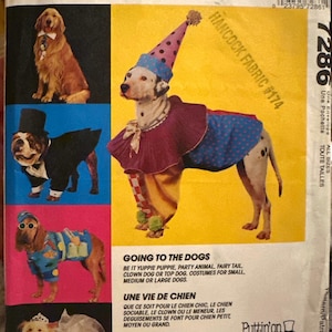 May include: McCall's sewing pattern envelope featuring dog costumes. The image shows a golden retriever in a tuxedo, a Dalmatian in a clown outfit, and other dogs in various costumes. Text includes "Going to the Dogs."