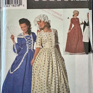 May include: Simplicity Costumes pattern featuring historical dresses. The package shows women in blue, yellow, and red dresses with white lace trim and bonnets. The pattern includes sizes 16, 18, and 20.