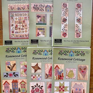 May include: A collection of six quilt pattern booklets titled "Rosewood Cottage" by Nancy Odom. Each booklet features a different quilt block design, with images of finished quilt blocks and the "Timid Thimble Creations" logo.