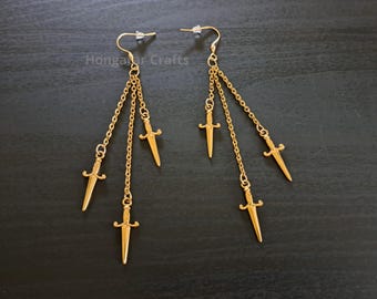 Pendientes colgantes con forma de daga, acero inoxidable tono dorado.